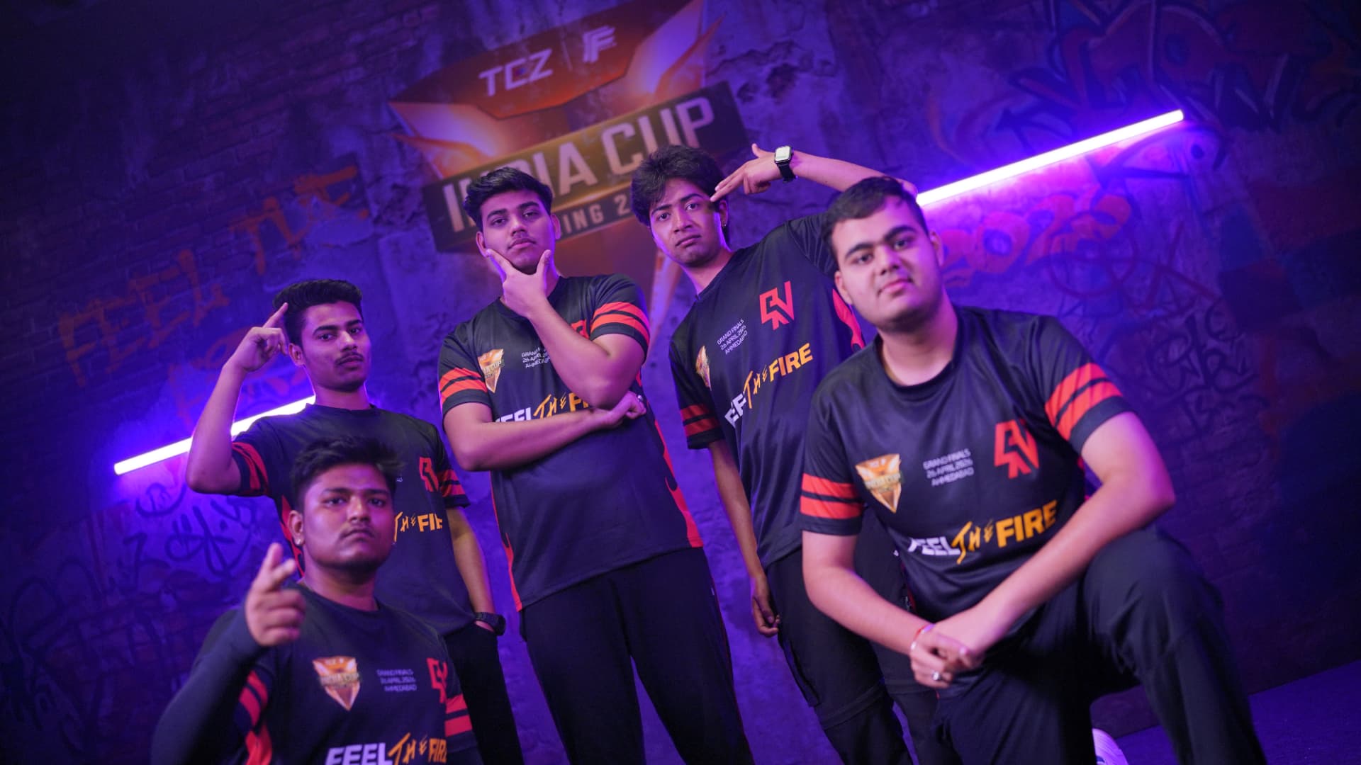 RNX Esports players posing under dramatic stage lighting